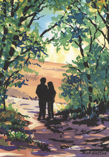 Two people standing on a path in woods with sunshine coming through the trees.